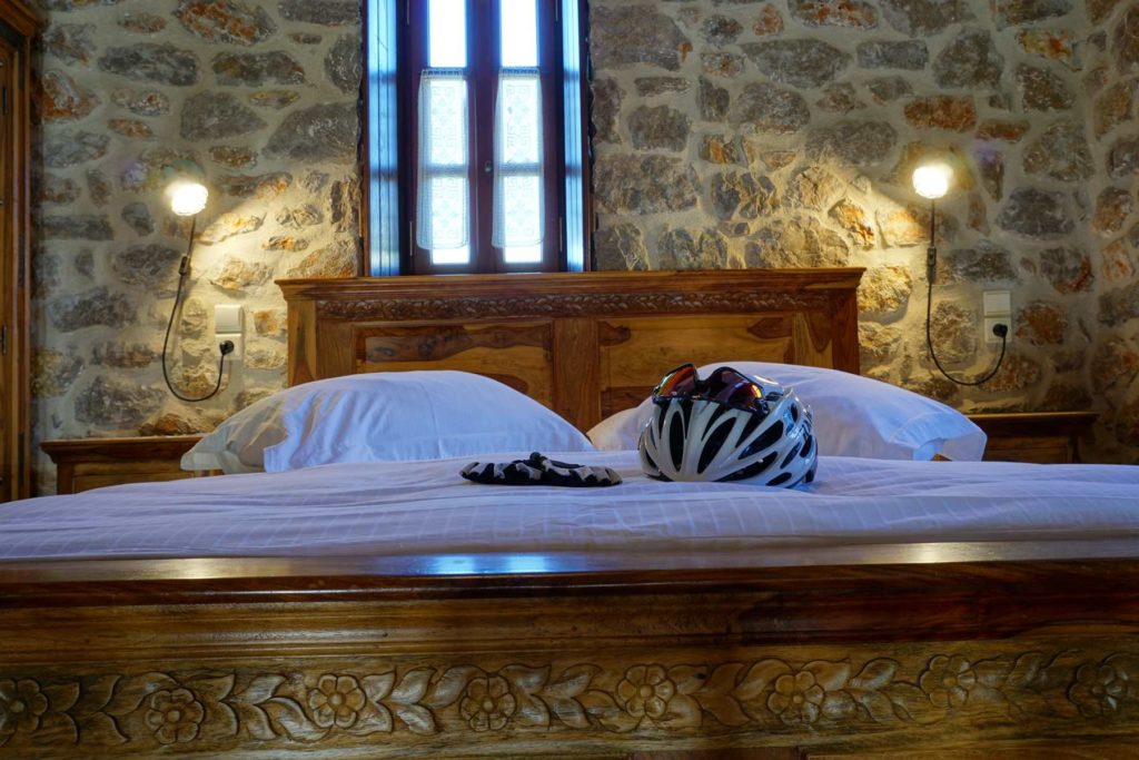 Helmet and cycling google on a bed in Argoktima hotel