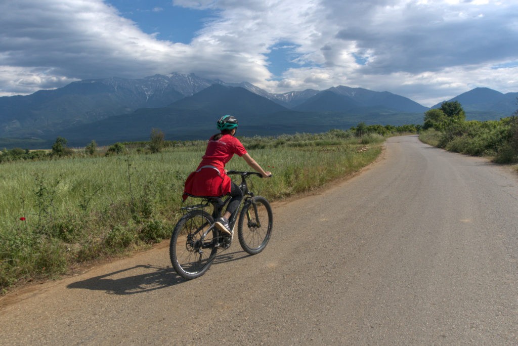 Female cyclist with mt. Olympus in the background