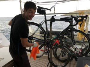Our guides are repairing the bikes on a catamaran sailing boat