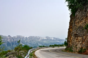 View of winding roads during a cycling ride with mountains covered with snow