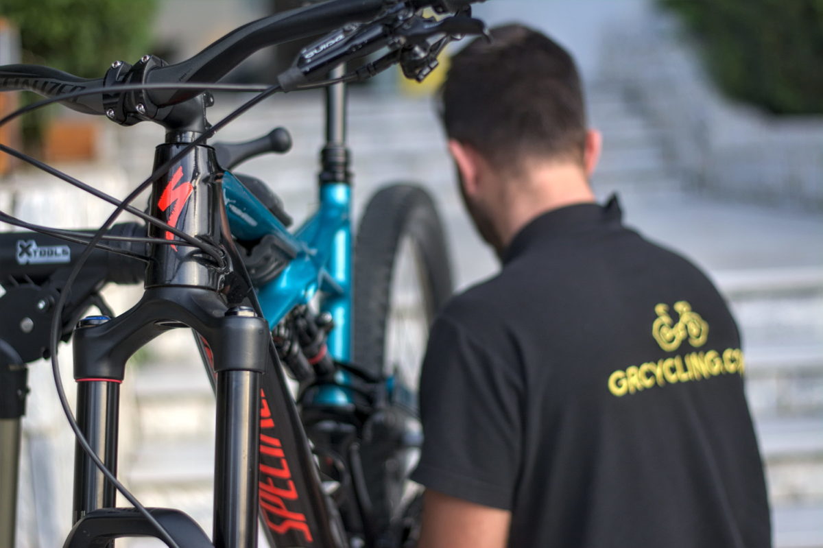 Bike mechanic is repairing a mountain bike