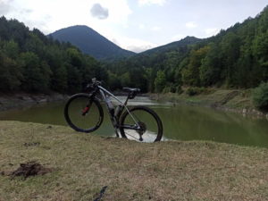 Mountain Bike in front of a river in Olympus Region