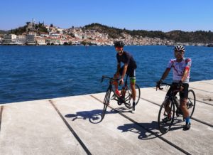 Two road cyclists at Galatas port having prior getting back to Porto Cheli