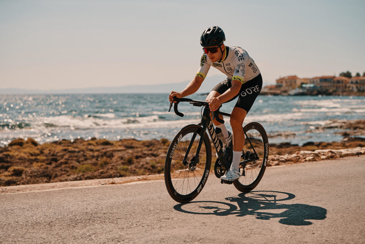 Road cyclist is cycling along the Greek coast